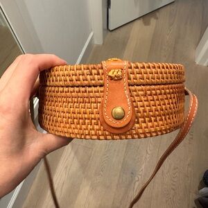 Crossbody bag, round with leather adjustable strap.